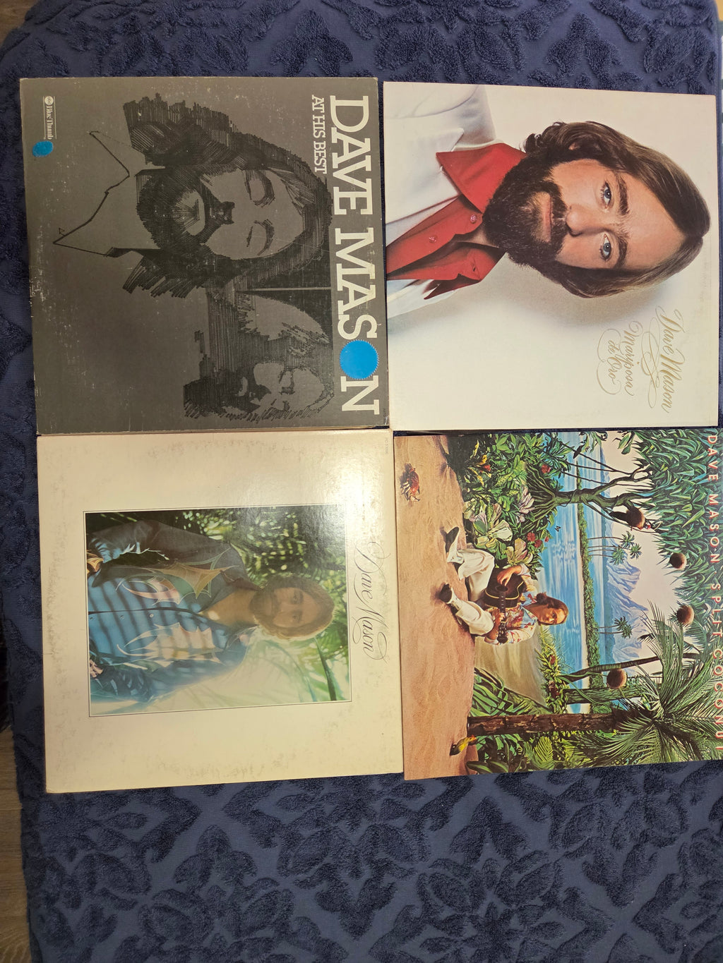 Four Dave Mason album covers on a textured blue surface